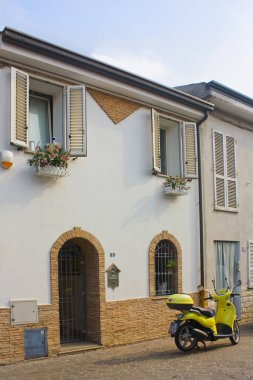 Rimini, İtalya - 26 Ağustos 2019: Sarı scooter eski Rimini kasabasının Picturesque San Giuliano ilçesine park edildi