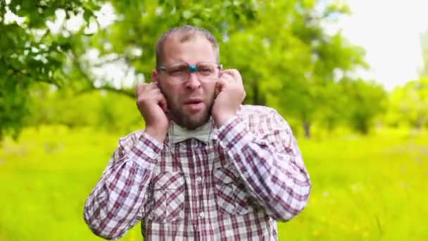 Mannen i glasögon som lyssnar på musik med hörlurar — Stockvideo