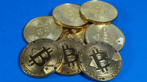 Varias monedas de bitcoins de oro sobre un fondo oscuro — Foto de Stock