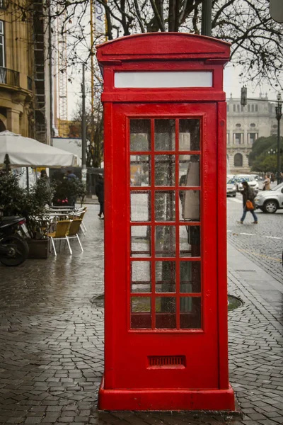 Red telephone booth. Tourist guide in Porto, Portugal.