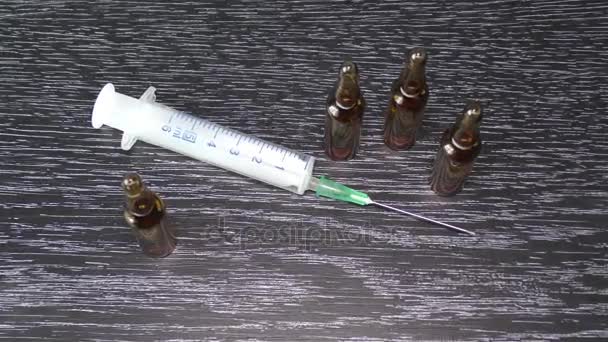 Injection and Medical Ampoules on a Black Background — Stock Video