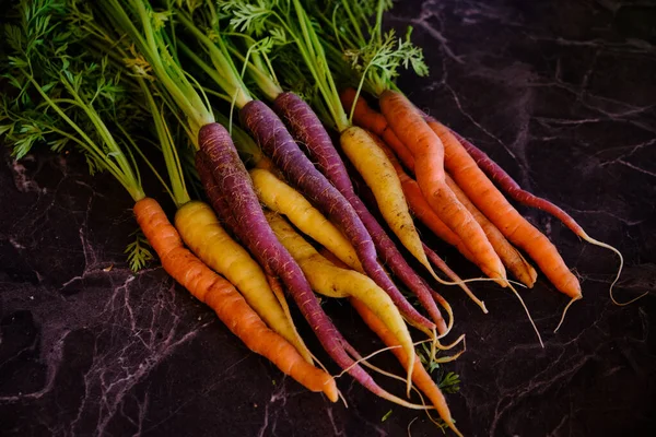 色彩艳丽的有机胡萝卜 黑色大理石背景的健康蔬菜 图库图片