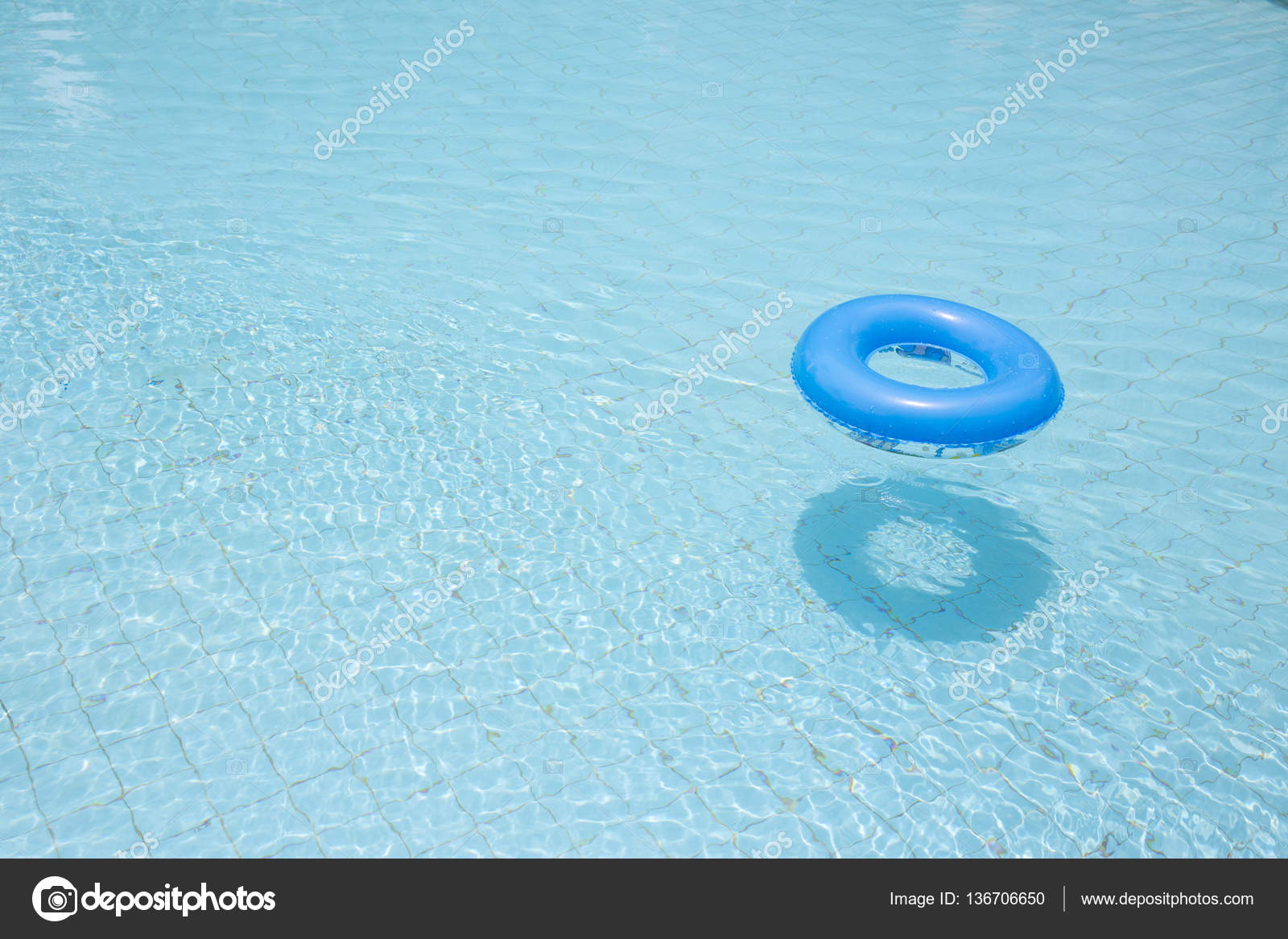 Blue swim ring for children flip over and float on swimming pool Stock Photo by ©Prathaan 136706650