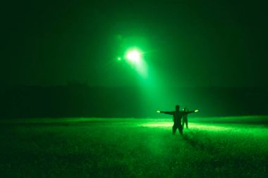 marshaller signal to helicopter for night landing from night vis clipart