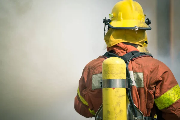 Firefighter fire fighting suround with dark smoke — Stock Photo, Image