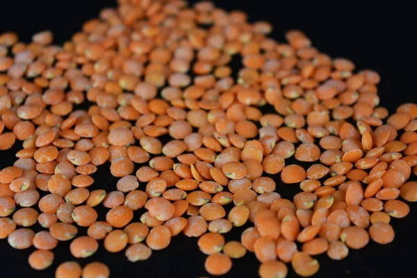 Grains Seeds Red Lentils Handful Lentils Located Scattered Black Plastic — Stock Photo, Image