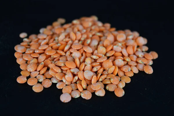 Grains Seeds Red Lentils Handful Lentils Located Scattered Black Plastic — 스톡 사진