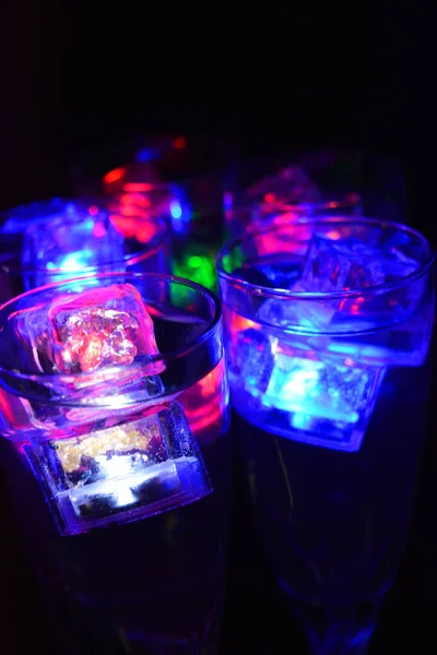 Five Glass Goblets Long Twisted Legs Ice Cubes Glowing Different — Stock Photo, Image