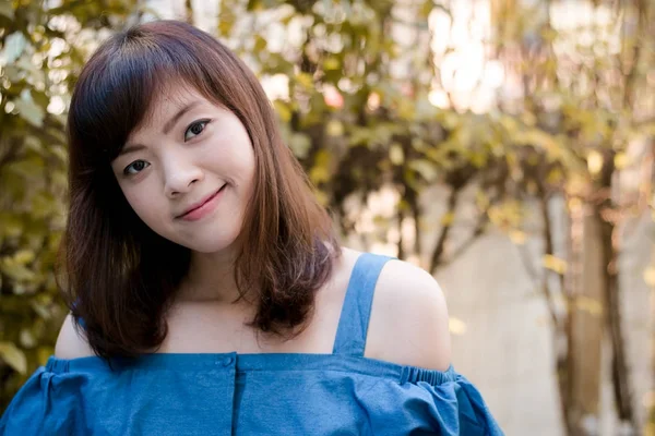 Close up of young pretty Asian woman in the garden. Stock Picture