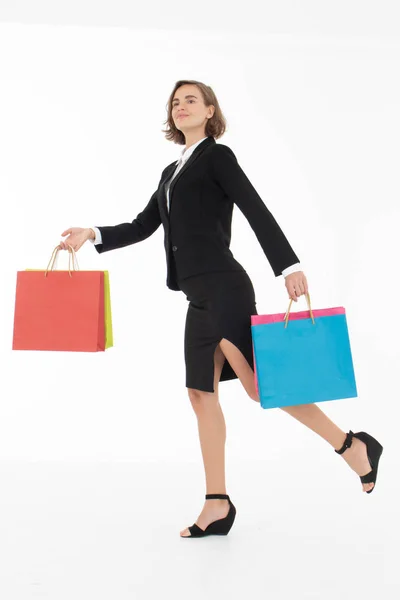Portret van een jonge zakenvrouw met boodschappentassen op wit — Stockfoto