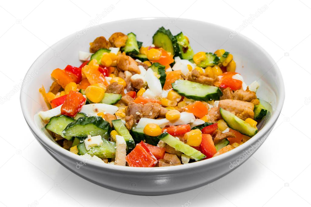 Bright vegetable salad in a white plate Isolated on a white background. Cooking a delicious dietary salad.