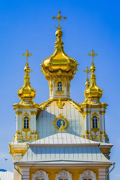 Christian church with beautiful golden domes against the blue sky. Beautiful golden domes of the Christian church shining in the sun on a blue sky background