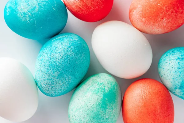 Multi-colored Easter eggs close-up on a white background. Festive background for design.