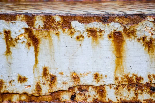 The texture of the old rusty metal. Streaks of rust on a white background. Use for design.