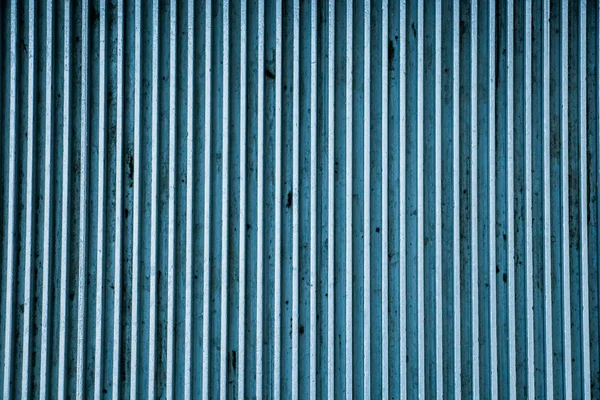 Striped blue metal plate texture close up