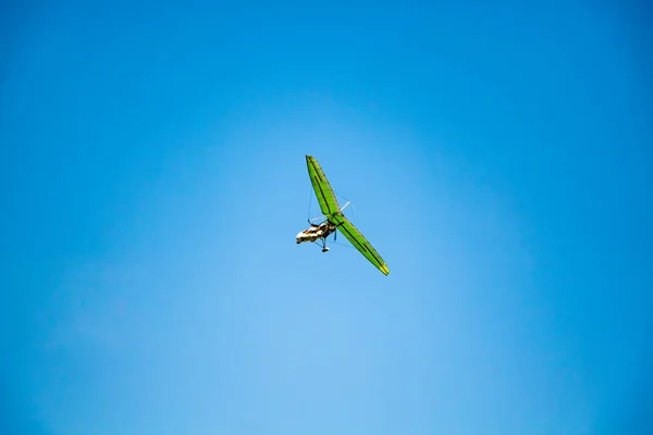 Hang glider in the blue sky. Extreme dangerous sport, air flights.