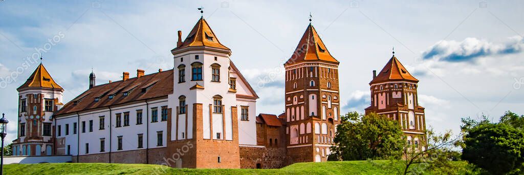 Mir, Belarus. Medieval castle on a background of blue sky. Summer landscape, ancient architecture, panoramic view. Banner format