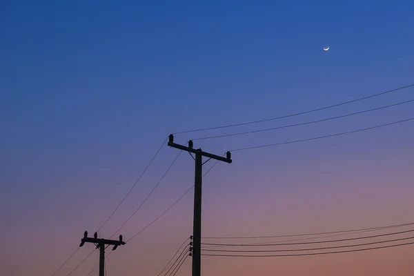 The silhouette electricity post in the twilight time — Stock Photo, Image