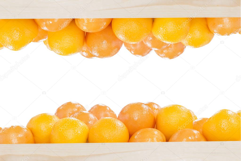 The pile of oranges in the wooden box