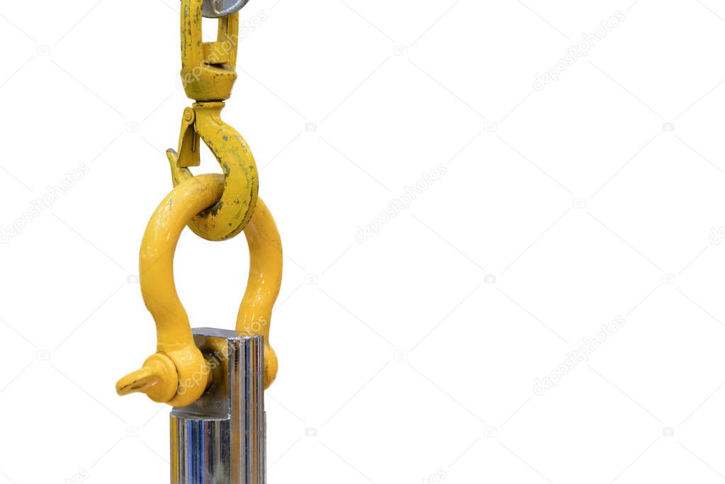 The yellow industrial hook hanging the steel rod 