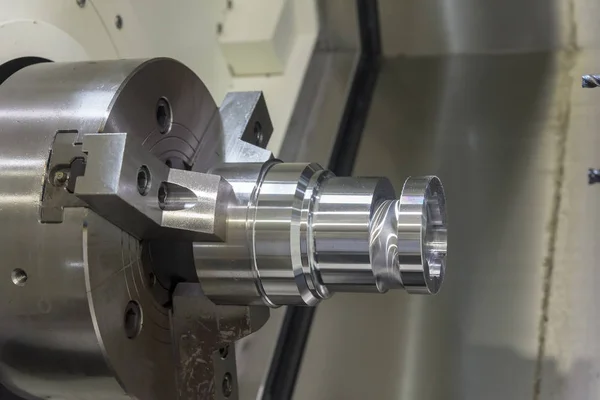 Close up of the CNC lathe jaw clamping  raw material steel rod . — Stock Photo, Image