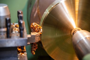 Torna makinesi, pirinç levha parçalarını kesme aletleriyle kesiyor. Makineyi döndürerek metal işleme süreci.