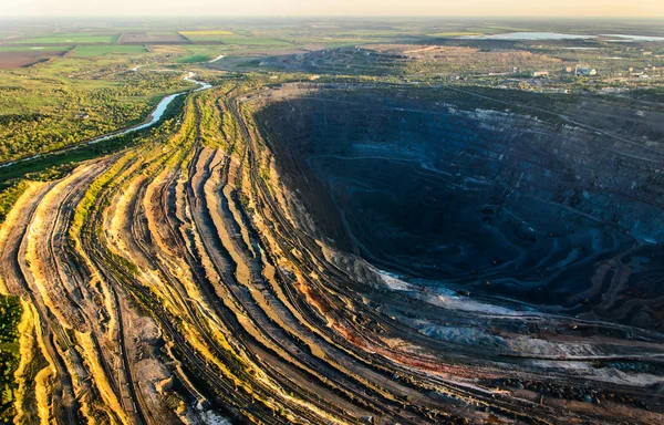 Aerial shot of huge open pit at sunset — Stock Photo, Image