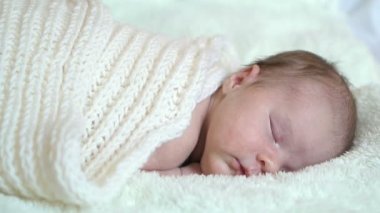 Infant baby portrait lie in white