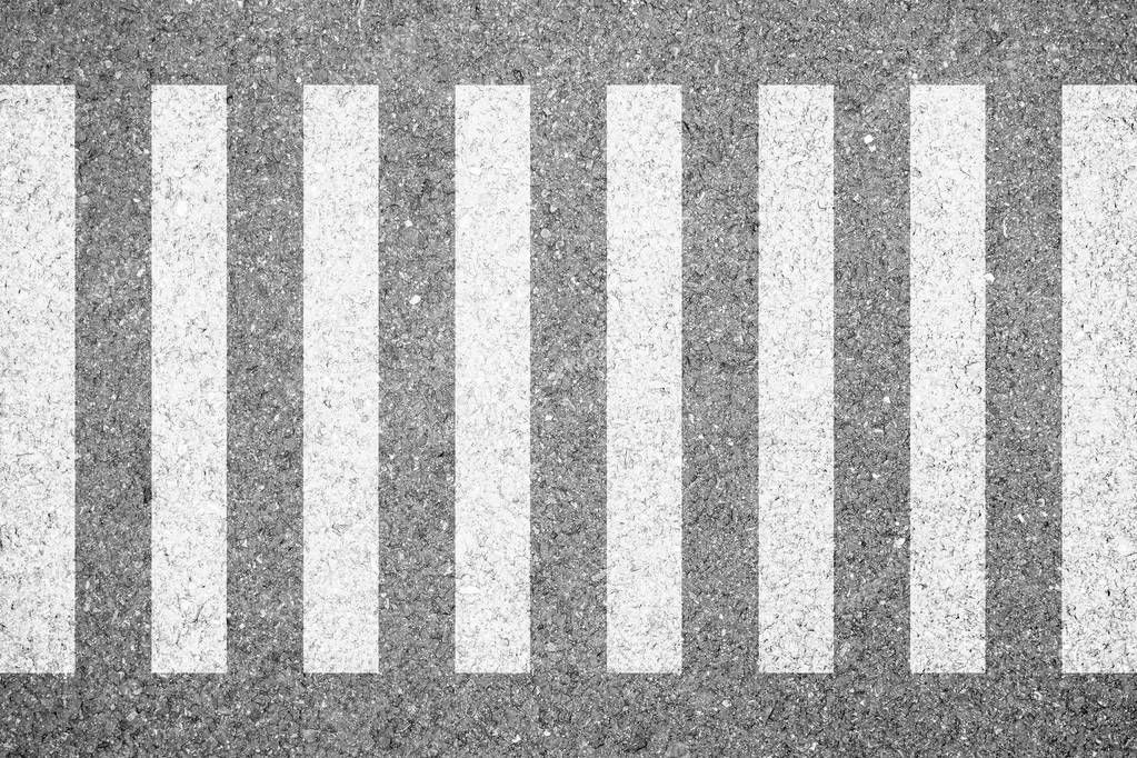 Zebra crosswalk on the road for safety when people walking cross the street.