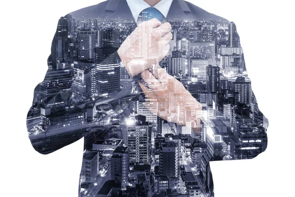 Double exposure of businessman in suit rearranging his tie and Osaka cityscape at night.