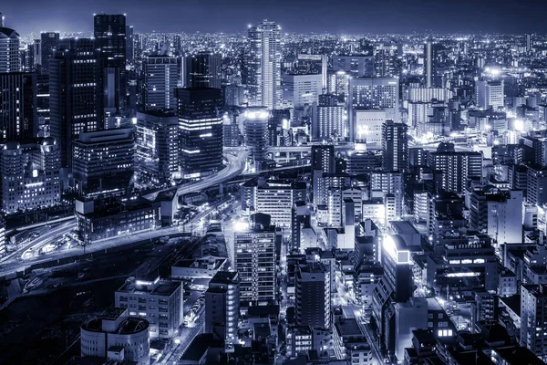 Oska city, Japan night view showing modern Japan big city with bright light and high tower. Monotone effect.