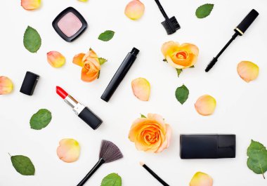 Dekoratif düz kozmetik ve çiçekler kompozisyonu yatıyordu. Beyaz arka plan üzerinde Üstten Görünüm