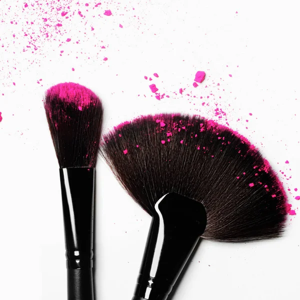 Makeup brush on white background with colorful pigment powder — Stock Photo, Image