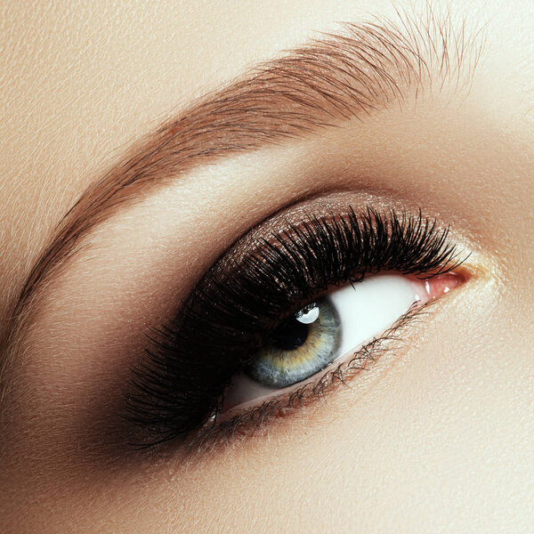 Beautiful macro shot of female eye with extreme long eyelashes