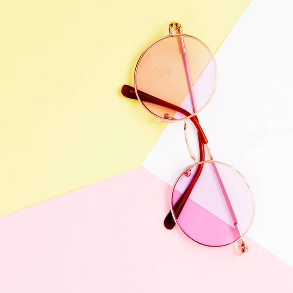 Minimalistische stijl. Minimalistische modefotografie. Mode zonnebril. De zomer is komende concept. Roze bril op een pastel achtergrond, bovenaanzicht. Trendy minimalistische stijl met kleurrijke papieren achtergrond — Stockfoto