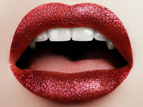 Glamour mode rouge vif lèvres maquillage avec des paillettes. Macro du visage de la femme. Maquillage des lèvres sexy brillant, dame de luxe — Photo