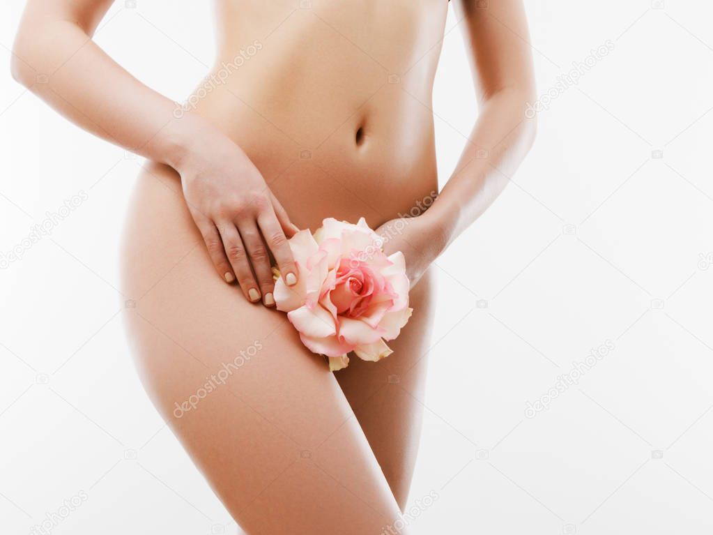 Women health and intimate hygiene. Beautiful Woman's body with smooth soft skin with flower. Epilation Concepts
