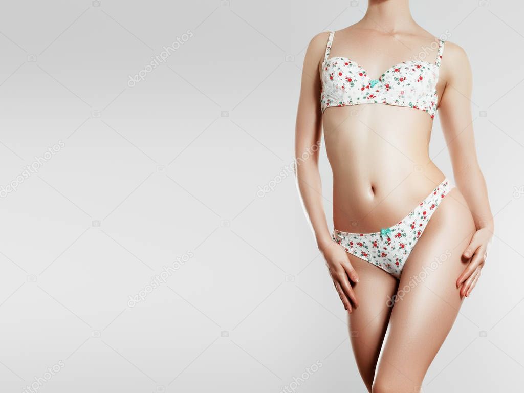 Beautiful slim woman body isolated on gray background