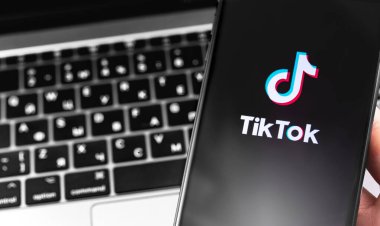 Ekrandaki akıllı telefon ve defter arkaplanındaki TikTok sembolü yakın plan. TikTok video yaratmak ve paylaşmak için bir uygulamadır. Moskova, Rusya - 23 Eylül 2019