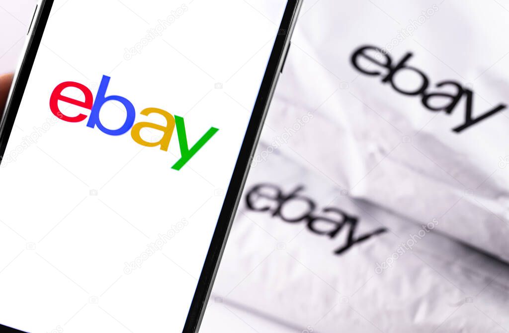 Ebay logo on the screen smartphone, Ebay plastic bag background closeup. eBay is one of the largest online auction and shopping websites. Moscow, Russia - March 23, 2019
