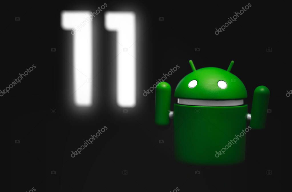 Google Android figure show Android 11 version on screen in the dark. Google Android is the operating system for smartphones, tablet computers, e-books, game consoles, and other devices. Moscow, Russia - December 18, 2019