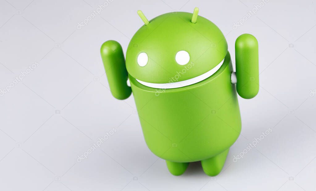 Google Android figure with raised hands on grey background. Google Android is the operating system for smartphones, tablet computers, e-books and other devices. Moscow, Russia - March 19, 2019