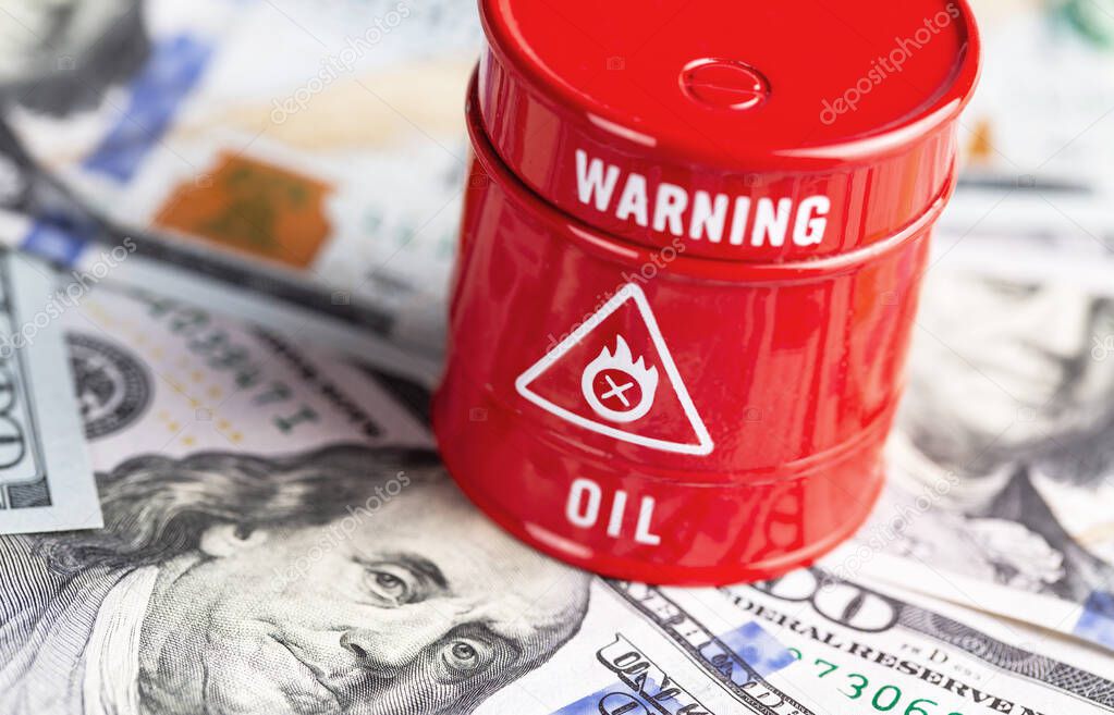 oil barrel with money, dollars banknotes closeup backgroun