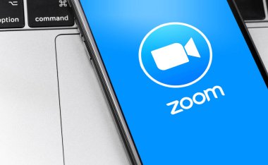 Akıllı telefon ve not defterindeki logo uygulamasını yakınlaştır. Zoom Video Communications, uzaktan konferans hizmeti veren bir şirket. Moskova, Rusya - 1 Nisan 2020