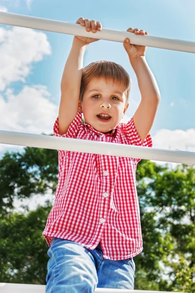 Αγόρι που ανεβαίνει σε μια σκάλα, μια προβολή κάτω, με τον ανοιχτό αέρα εναντίον — Φωτογραφία Αρχείου