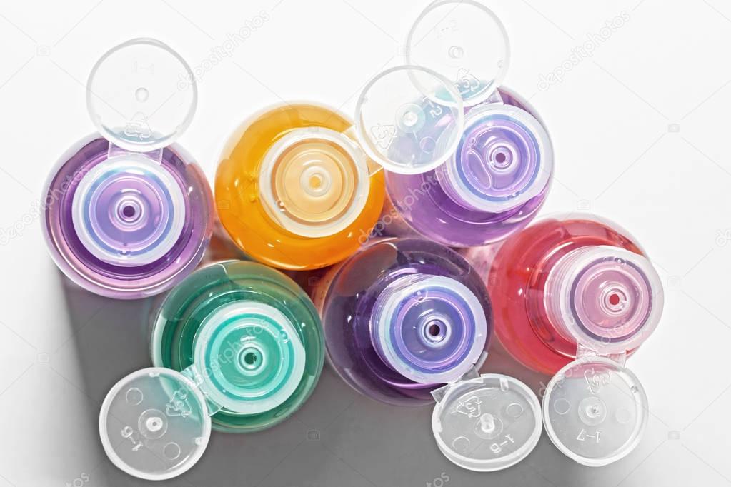 colored bottles for cosmetics, cosmetics and shampoos, top view