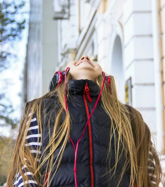 Hermosa chica adolescente con auriculares mirando hacia arriba , — Foto de Stock