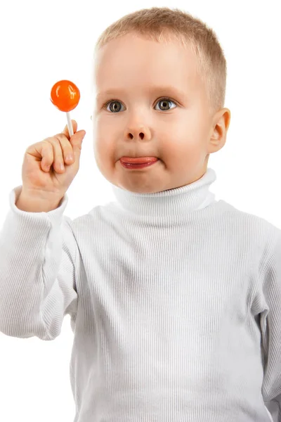 Fröhlicher kleiner Junge isst Süßigkeiten-Lutscher, — Stockfoto