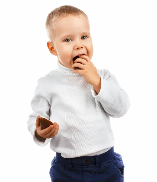 Little boy eating a delicious chocolate Easter egg Royalty Free Stock Photos
