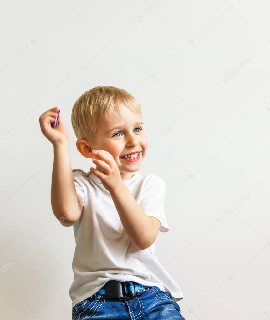 happy cheerful little boy, playing laughing making a face  